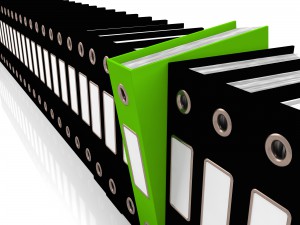 Green File Amongst Black For Getting Office Organized