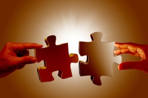 two-people-holding-puzzle-pieces-min
