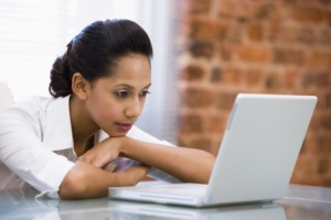 Business Woman Looking at Laptop