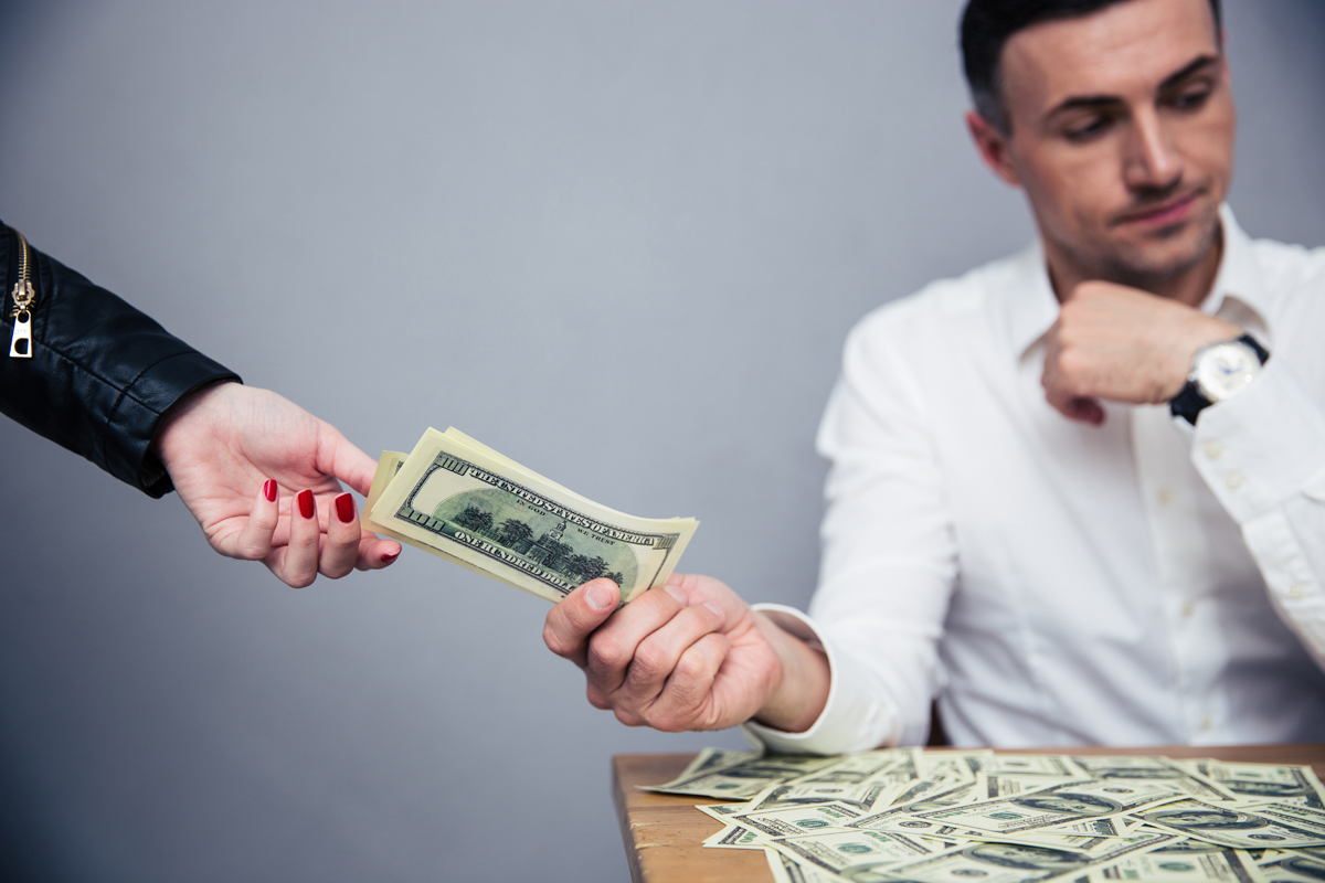 Unhappy Man Giving Money To Woman Backbone America