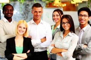 Happy group of co-workers standing in office
