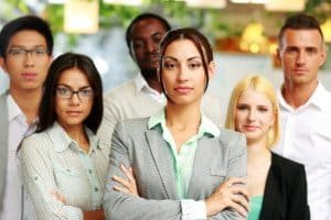 Group of co-workers standing in office