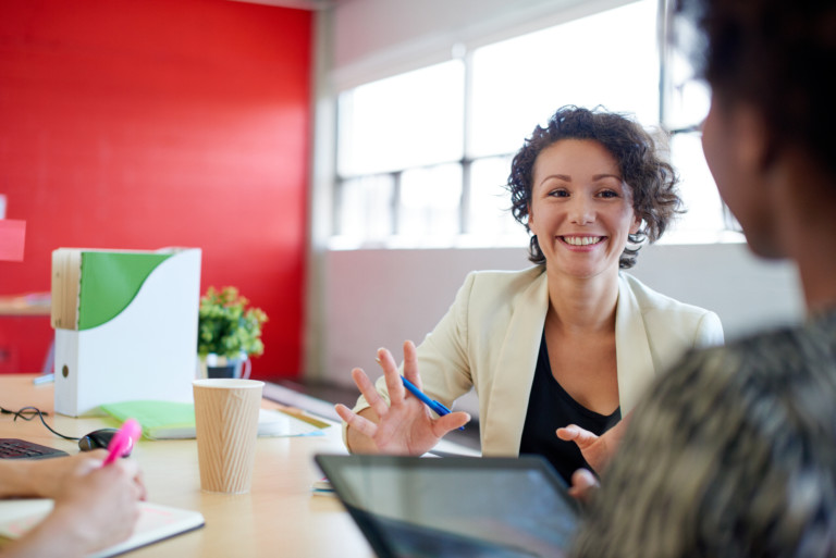 A happy woman receiving small business coaching