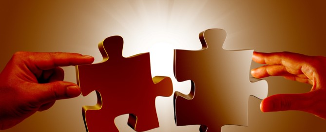 two-people-holding-puzzle-pieces-min
