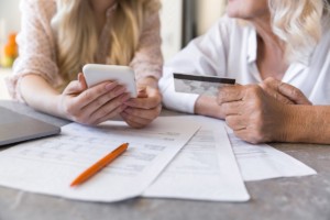 Women doing credit card calculations