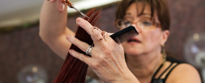 woman giving haircut - best hair salons