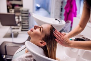 woman getting hair washed - hair salon business plan